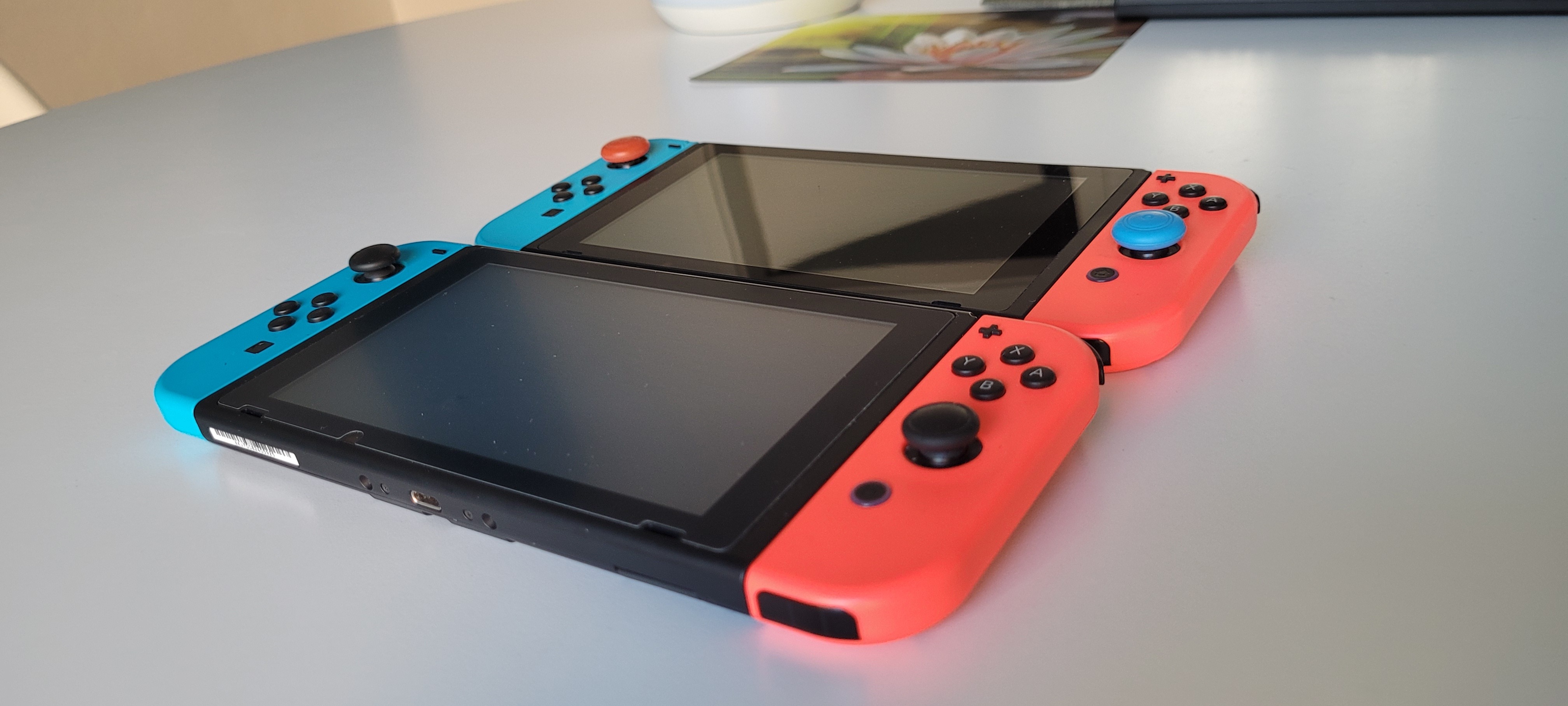 Two Nintendo Switch consoles side by side on the table