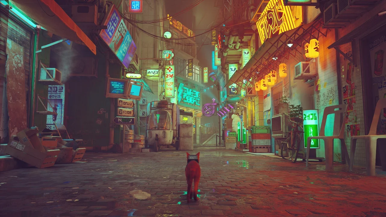 Stray Review: The main character of the game, the cat, standing in a brightly lit, futuristic street