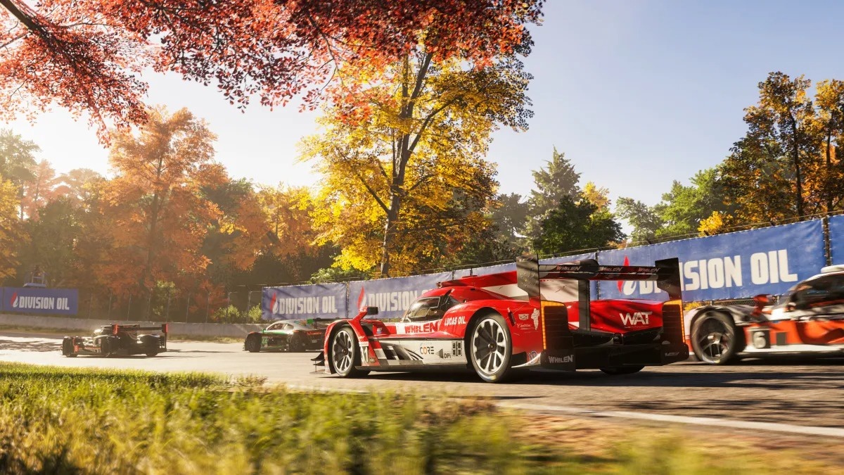 A sunlit race track with multiple sports cars on the track